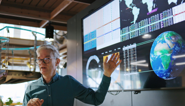 A man presenting a screen with data
